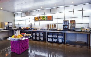 A modern breakfast buffet with a variety of food options and self-service beverage dispensers. - Holiday Inn Express Lisbon - Alfragide by IHG (Oeiras)