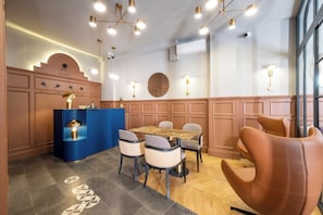 A modern dining area with a central table, chairs, and a blue counter. - Balo (Istanbul)
