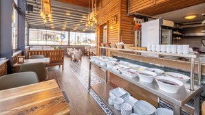 A restaurant with wooden interiors, a buffet counter, and seating arrangements. - Balo (Istanbul)
