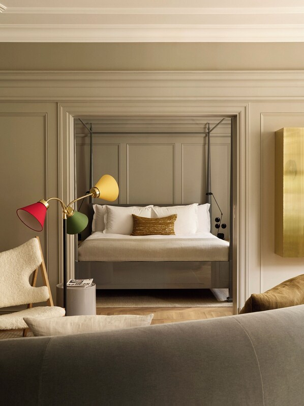 A modern bedroom with a bunk bed, a bedside table, a lamp, and a chair. - Ett Hem (Stockholm)