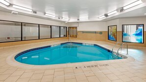 An indoor swimming pool with clear lane markings, a diving board, and safety signage. - Comfort Inn & Suites Verona at Turning Stone Resort Casino (Verona)