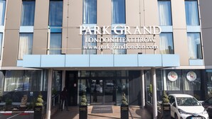 A modern building with the sign "Park Grand London Heathrow" and a website address.