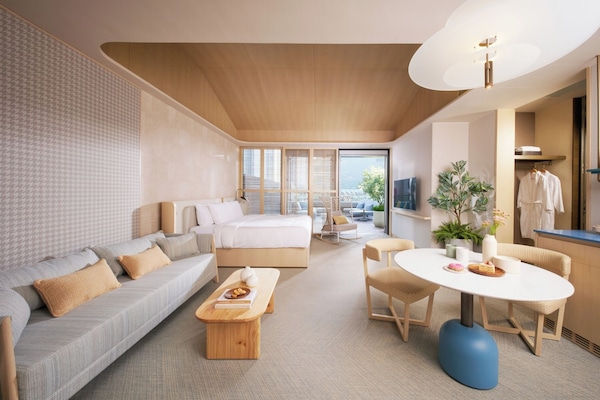 Sunset Terrace Suite | Minibar, in-room safe, desk, blackout drapes