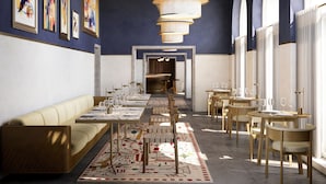 A modern dining area with a long table, cushioned seating, and a patterned rug. - Villa Orsula (Dubrovnik)
