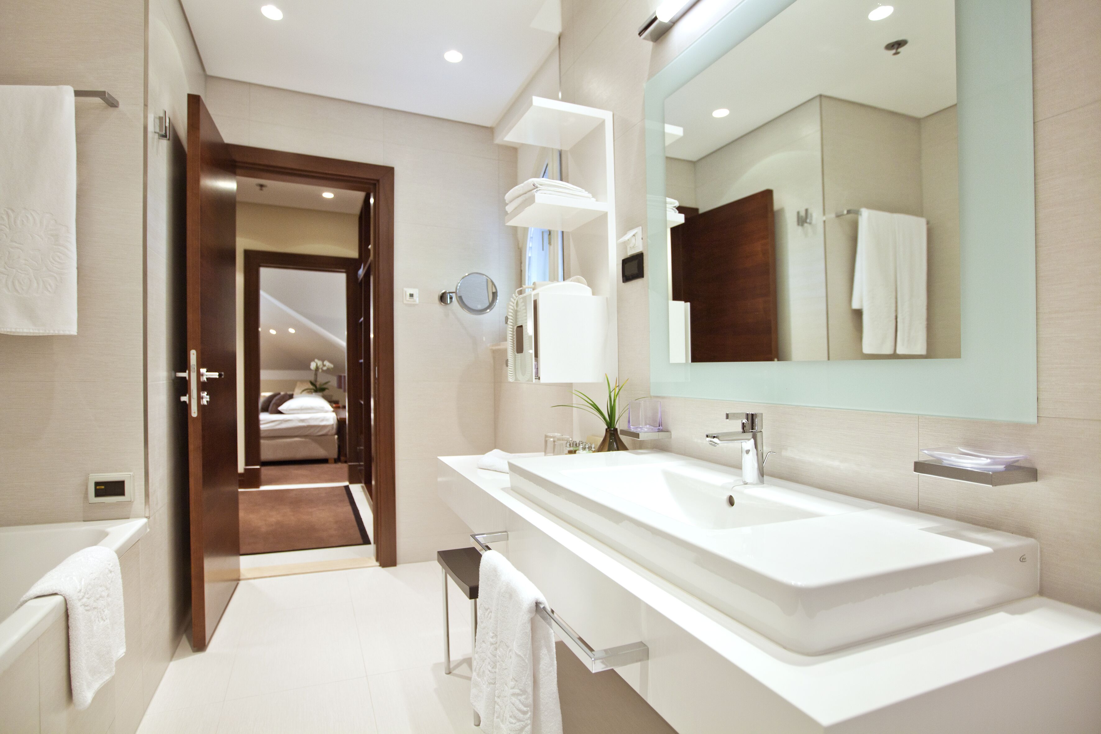 designer toiletries, hair dryer, slippers, towels