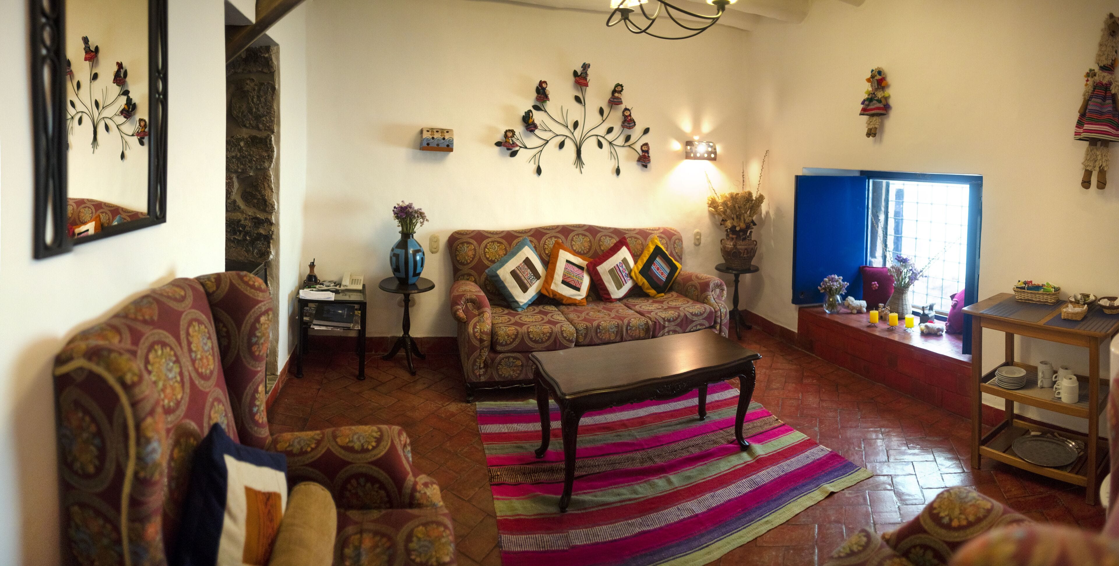 A cozy living room with patterned sofas, a coffee table, and decorative items.
