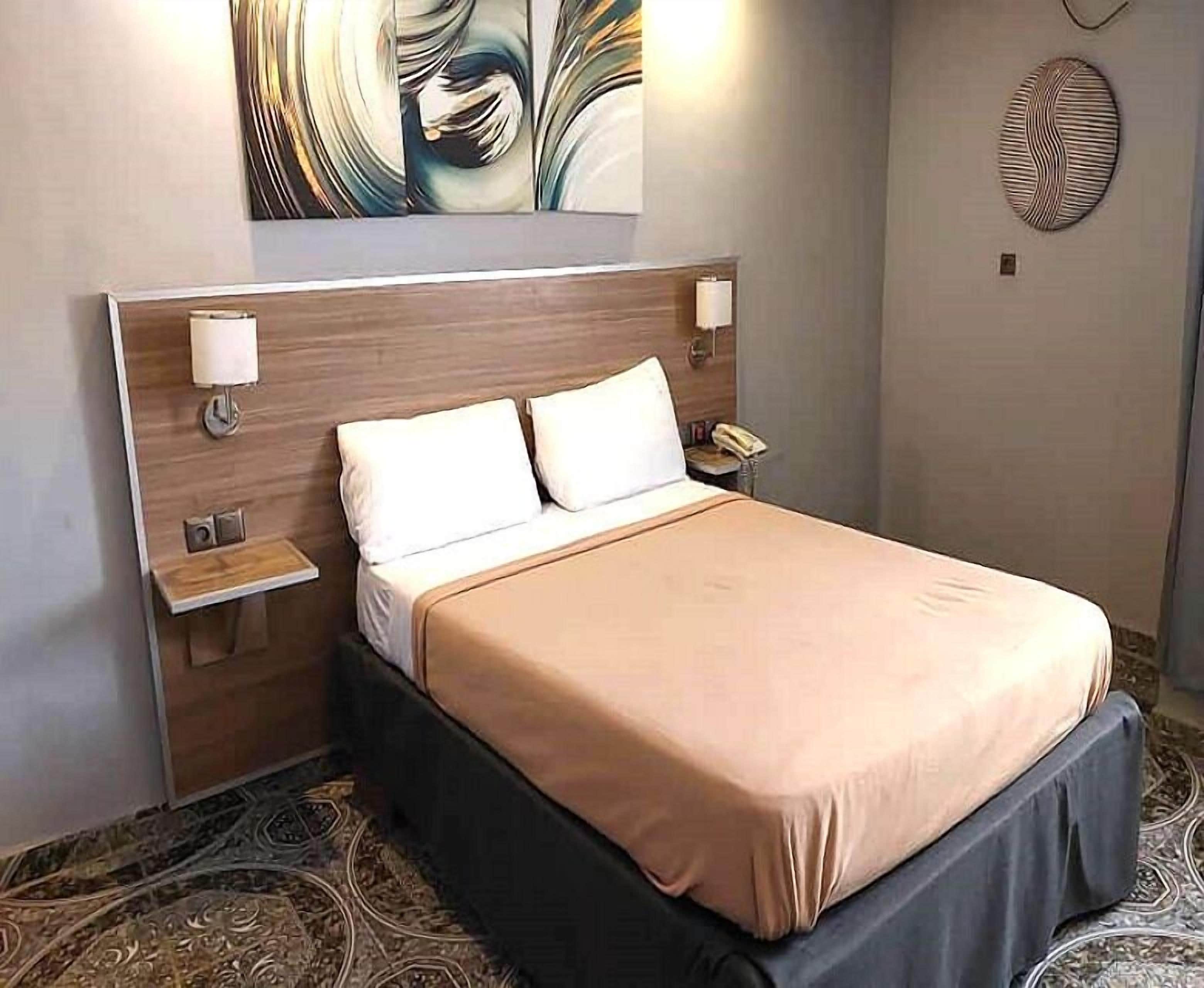 Standard Double Room | Minibar, individually furnished, desk, blackout drapes