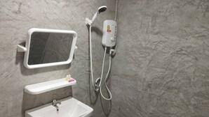 A bathroom with a white sink, a mirror, and a handheld showerhead. -  The Relax Beach Resort (Ko Pha-ngan)