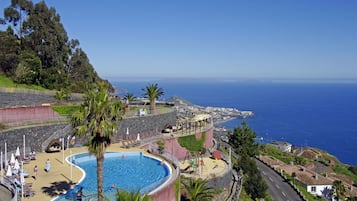 Piscine couverte, piscine extérieure, parasols de plage, chaises longues