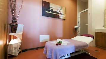 Cozy retreat with a single bed, table, and vase, perfect for a relaxing stay.