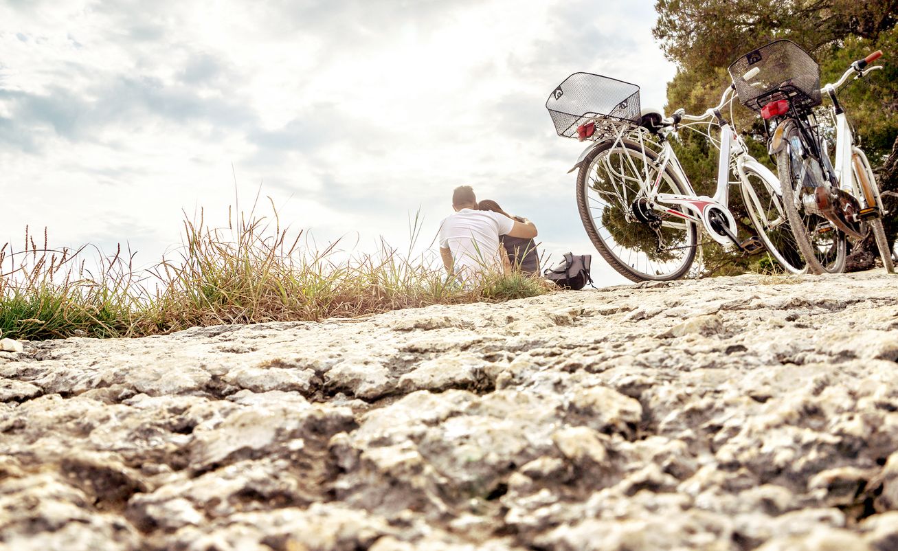 A rocky terrain with two bicycles parked.