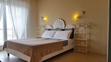 A bed with a headboard, two wall-mounted lights, and a bedside table.