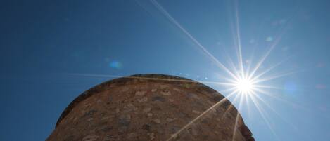 A circular stone structure with a clear sky in the background.