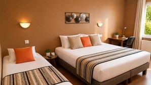 A hotel room with two beds, a desk, a chair, a small table with a plant, and a window with curtains.