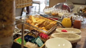 A buffet with various food items and beverages.