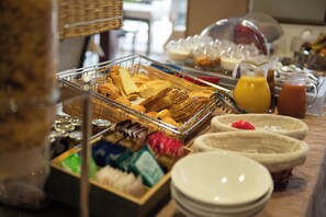 A buffet with various food items and beverages.