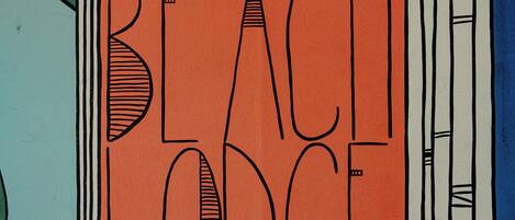 A colorful abstract design with the text "CORAL BEACH ODG" prominently displayed.