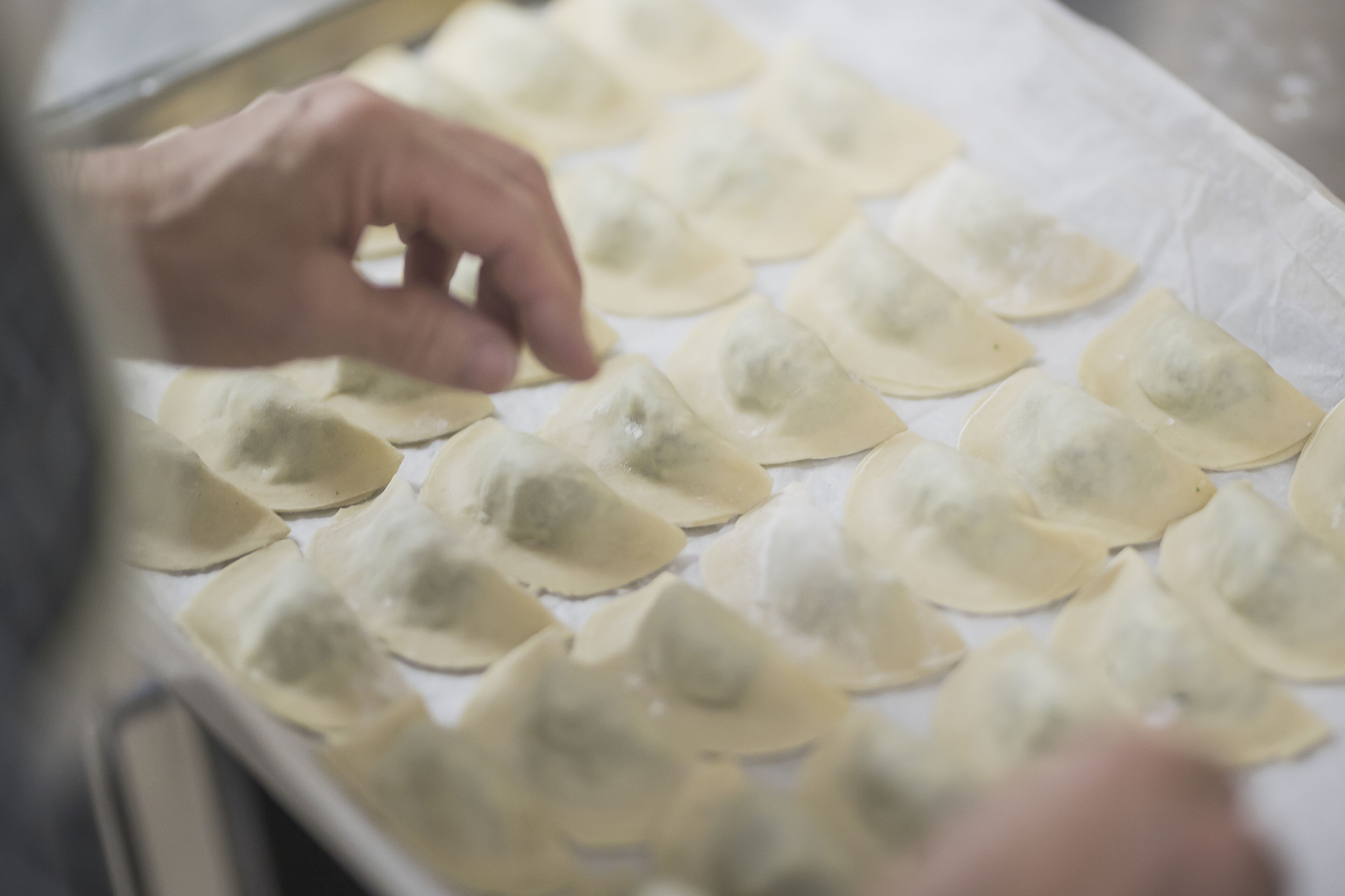 A tray of dumplings being prepared.