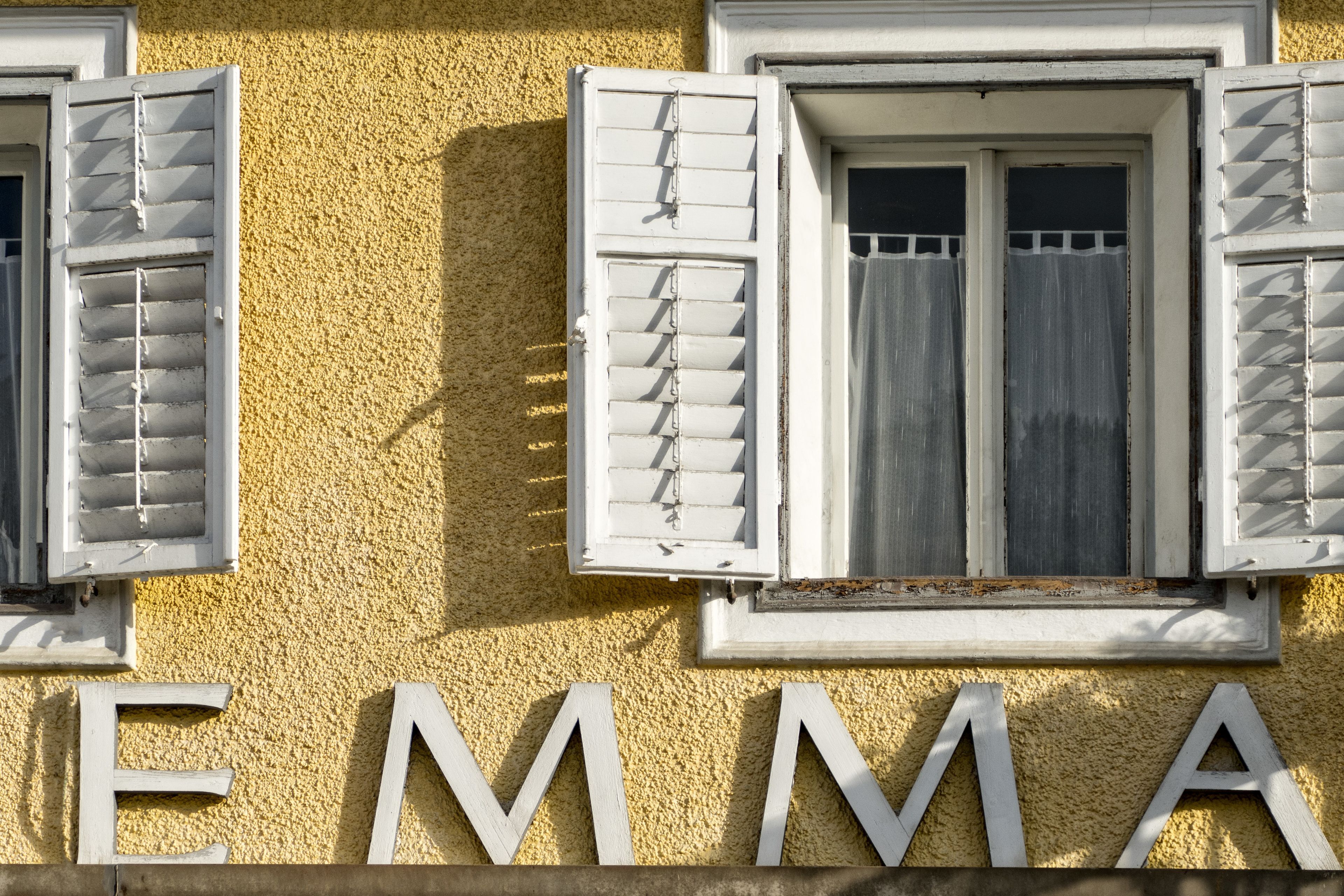 A building facade with the name 'EMMA' in large white letters.
