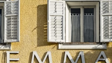 A building facade with the name 'EMMA' in large white letters.