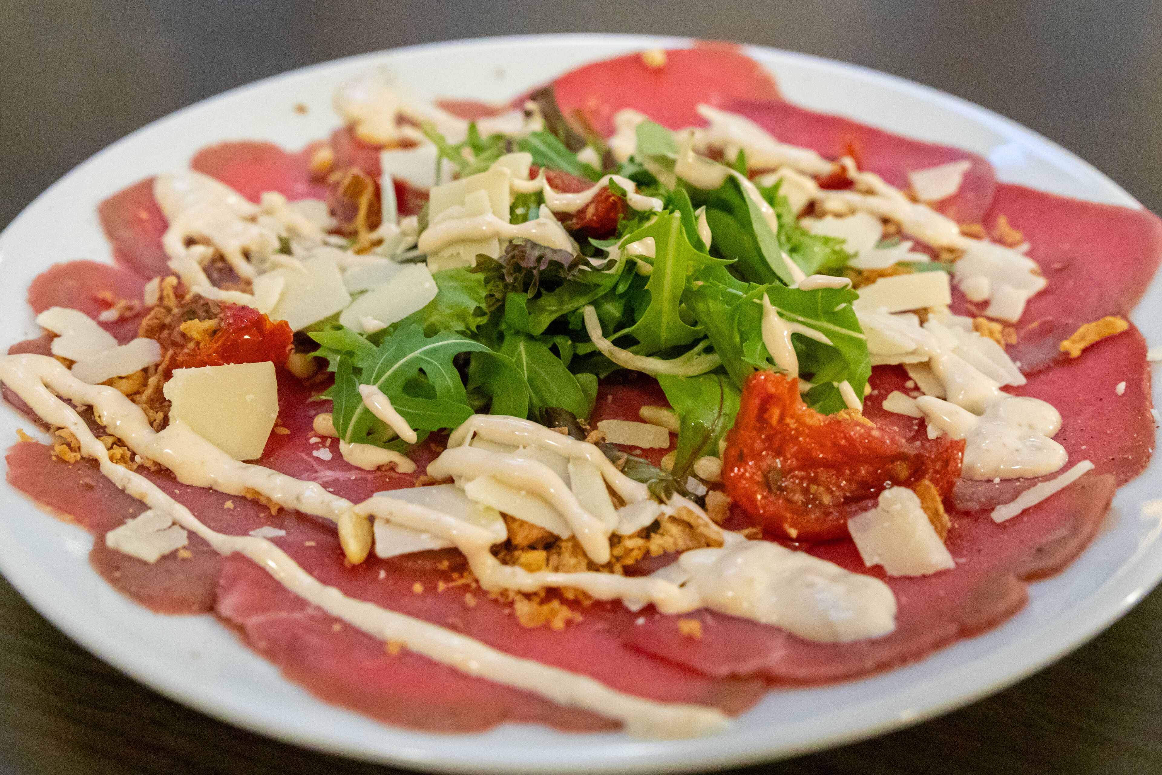 A plate of food with various toppings and sauces.