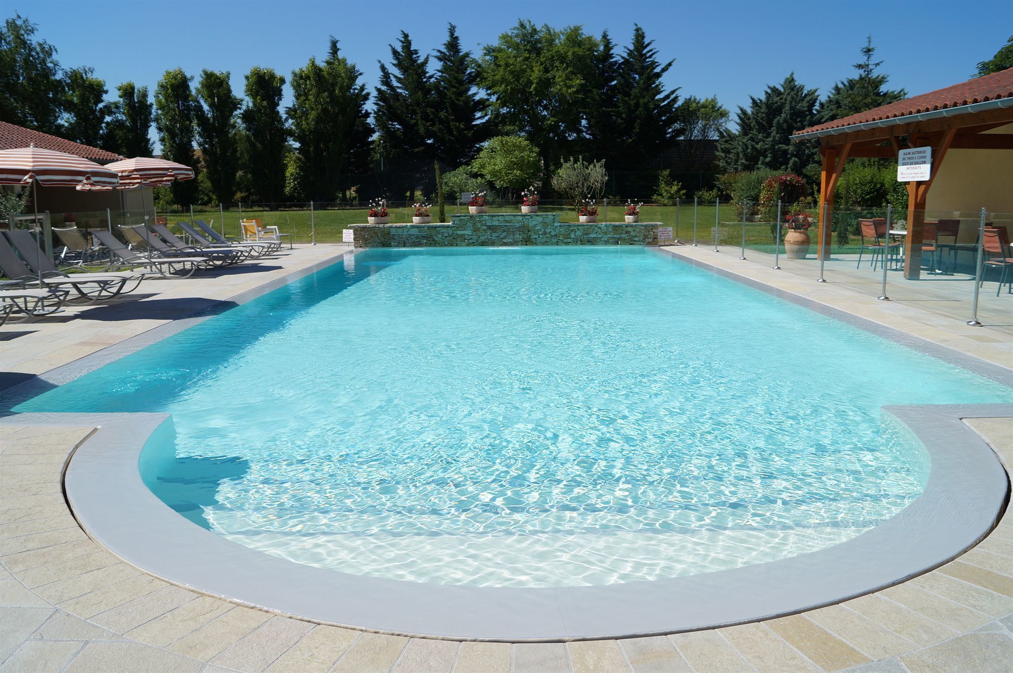 Seasonal outdoor pool, open 8:00 AM to 9:00 PM, pool umbrellas