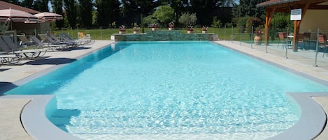 Seasonal outdoor pool, open 8:00 AM to 9:00 PM, pool umbrellas