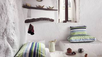 Relax in a cozy room with a comfortable seating area and a window offering a view.