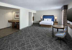 A hotel room with a bed, a desk, a chair, a TV, and a bathroom. - Hampton Inn and Suites New Hartford/Utica (New Hartford)