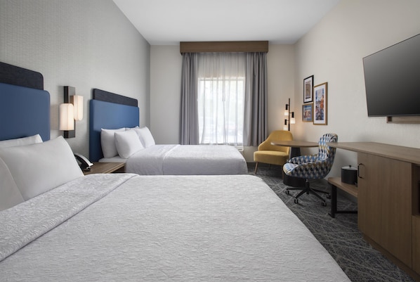 A hotel room with two beds, a desk, a chair, a television, and a window with curtains. - Hampton Inn and Suites New Hartford/Utica (New Hartford)