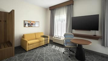 A hotel room with a sofa, a chair, a TV, a painting, and a window with curtains.