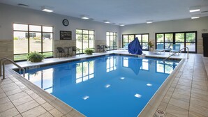 An indoor swimming pool with clear water, tiled floor, and a lifeguard sign on the wall. - Hampton Inn and Suites New Hartford/Utica (New Hartford)
