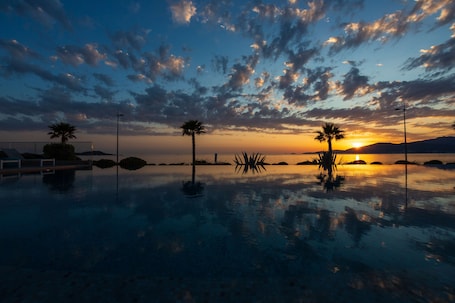 Outdoor pool, pool umbrellas, sun loungers. Radisson Blu Resort & Spa Ajaccio Bay