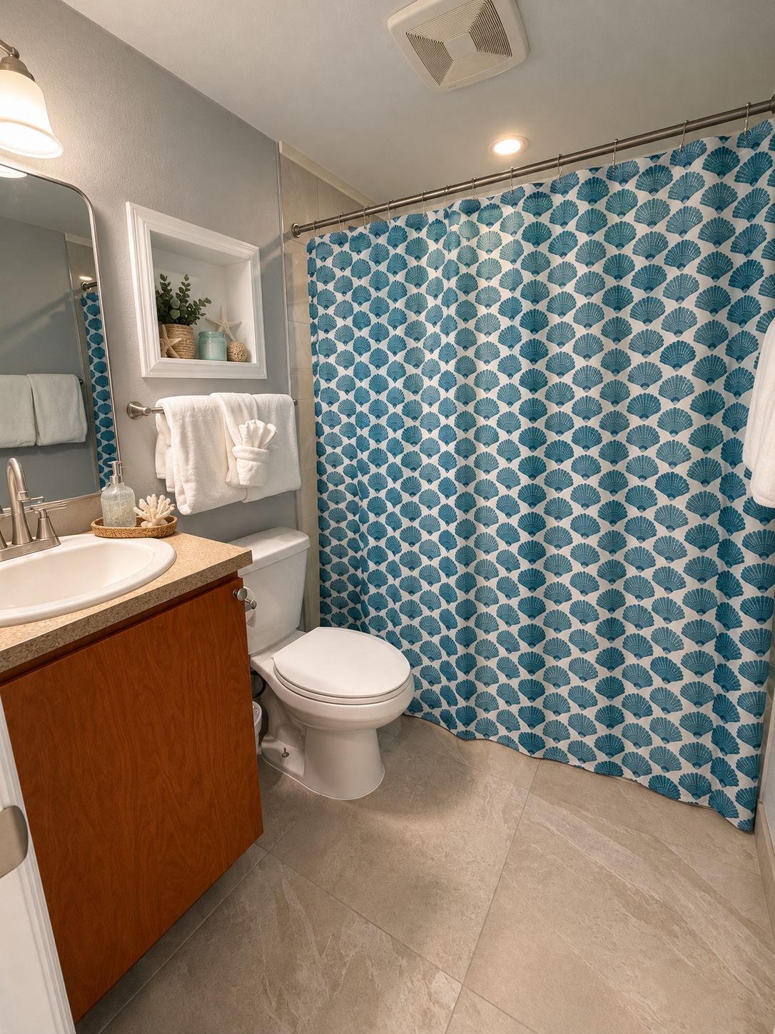 A bathroom with a toilet, sink, and shower curtain.