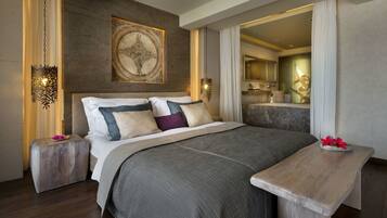 A modern bedroom with a large bed, a wooden bench, and a decorative wall piece.