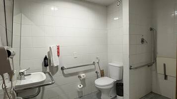 A bathroom with a sink, toilet, and shower.