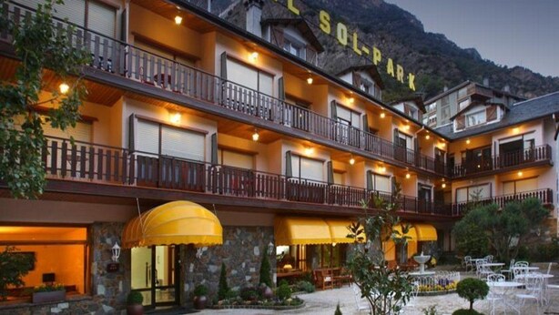 A multi-story hotel with balconies, a sign reading "Hotel Sol Park," and a stone facade. - Sol Park (Sant Julia de Loria)
