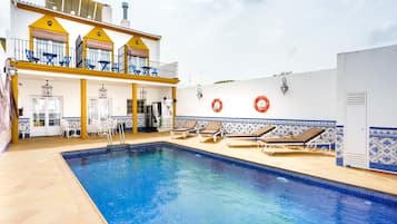 Seasonal outdoor pool, open 11:00 AM to 9:30 PM, pool loungers