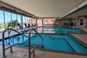 An indoor swimming pool with clear glass walls, multiple lanes, and a lifeguard station. - Cambria Hotel Rapid City near Mount Rushmore (Rapid City)