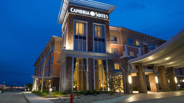 A multi-story hotel with a prominent sign for 'Cambria Suites' at the top.