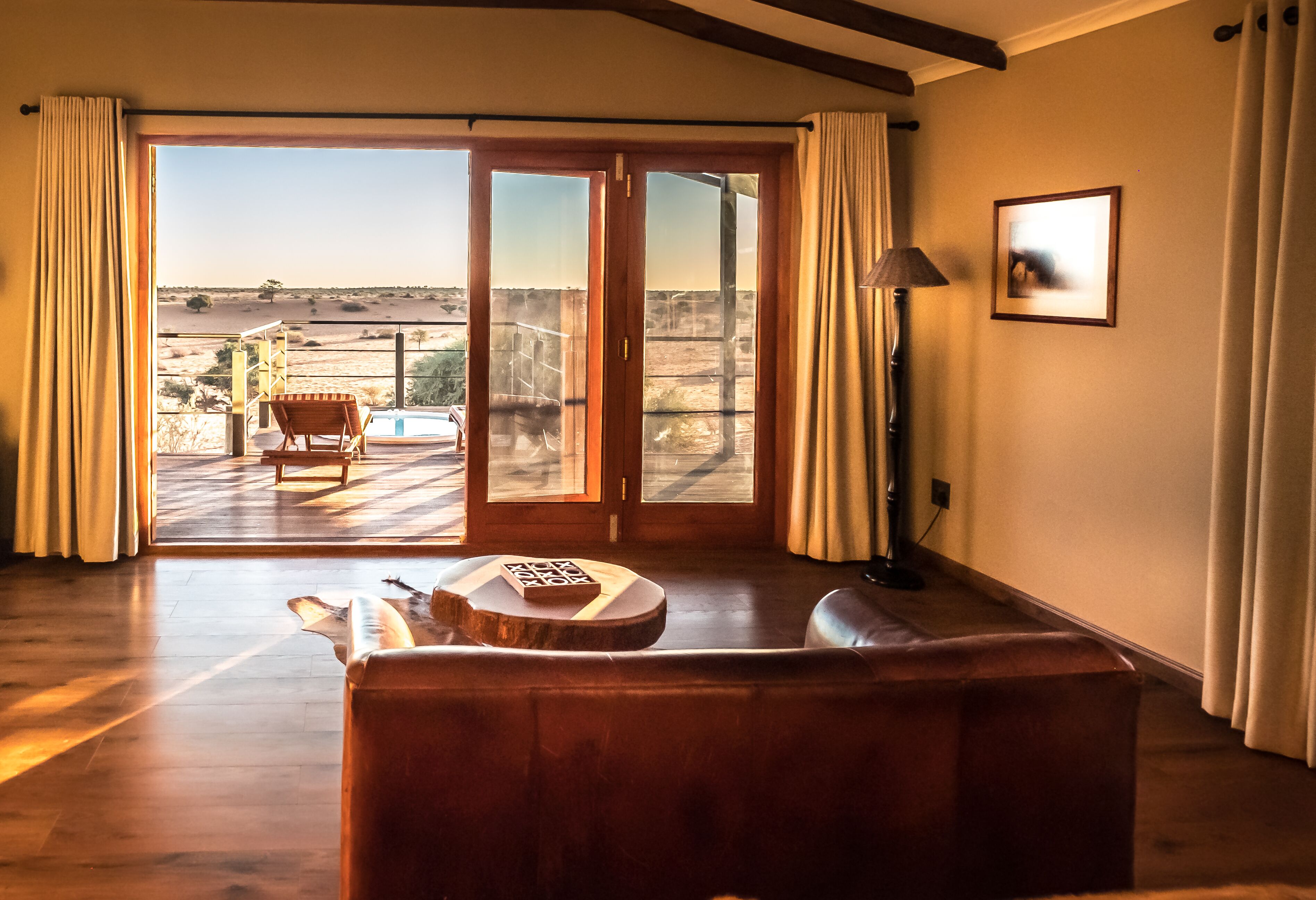 A spacious living room with a large sliding glass door leading to an outdoor terrace.