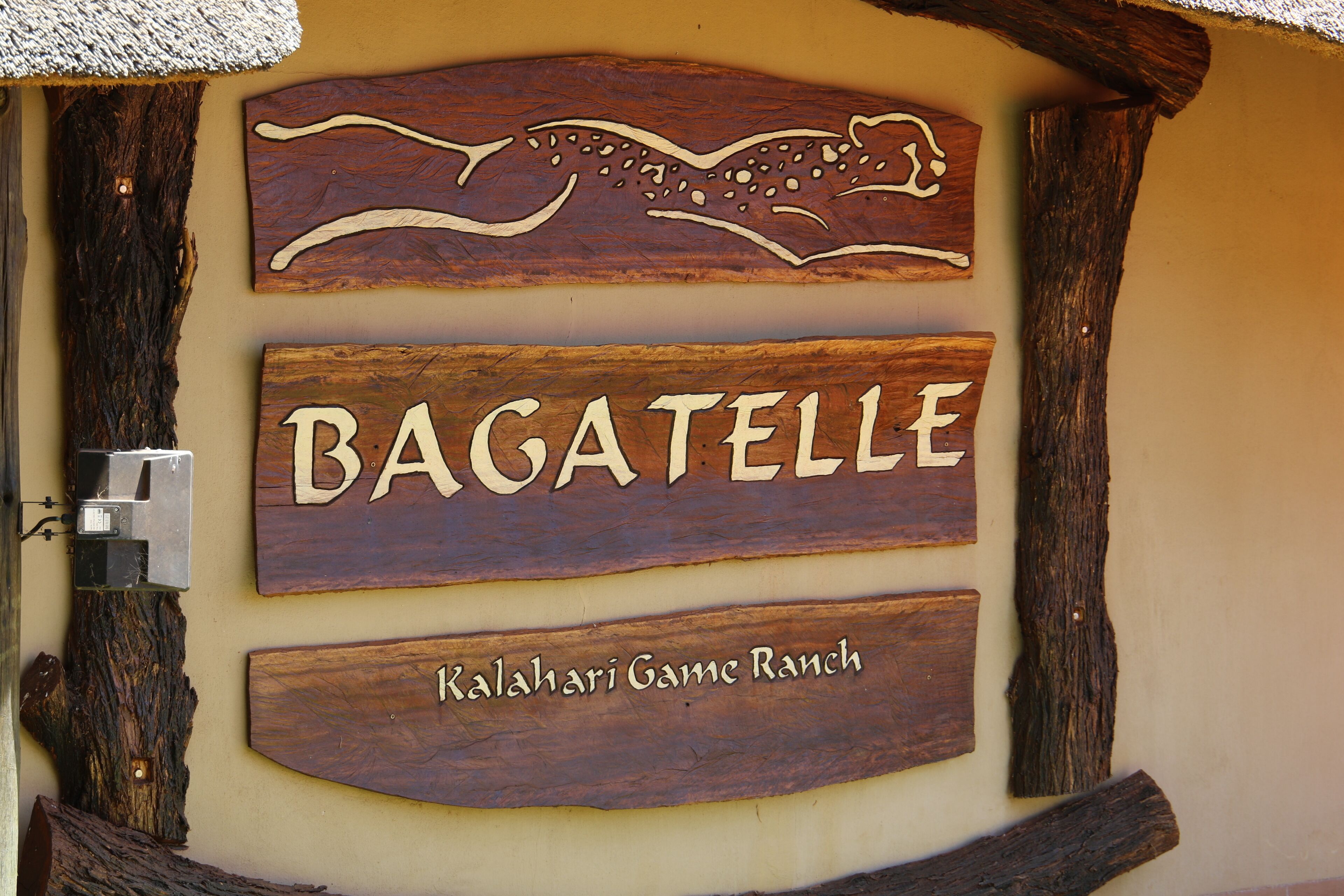 A wooden sign with the name 'BAGATELLE' and 'Kalashari Game Ranch' indicating a location.