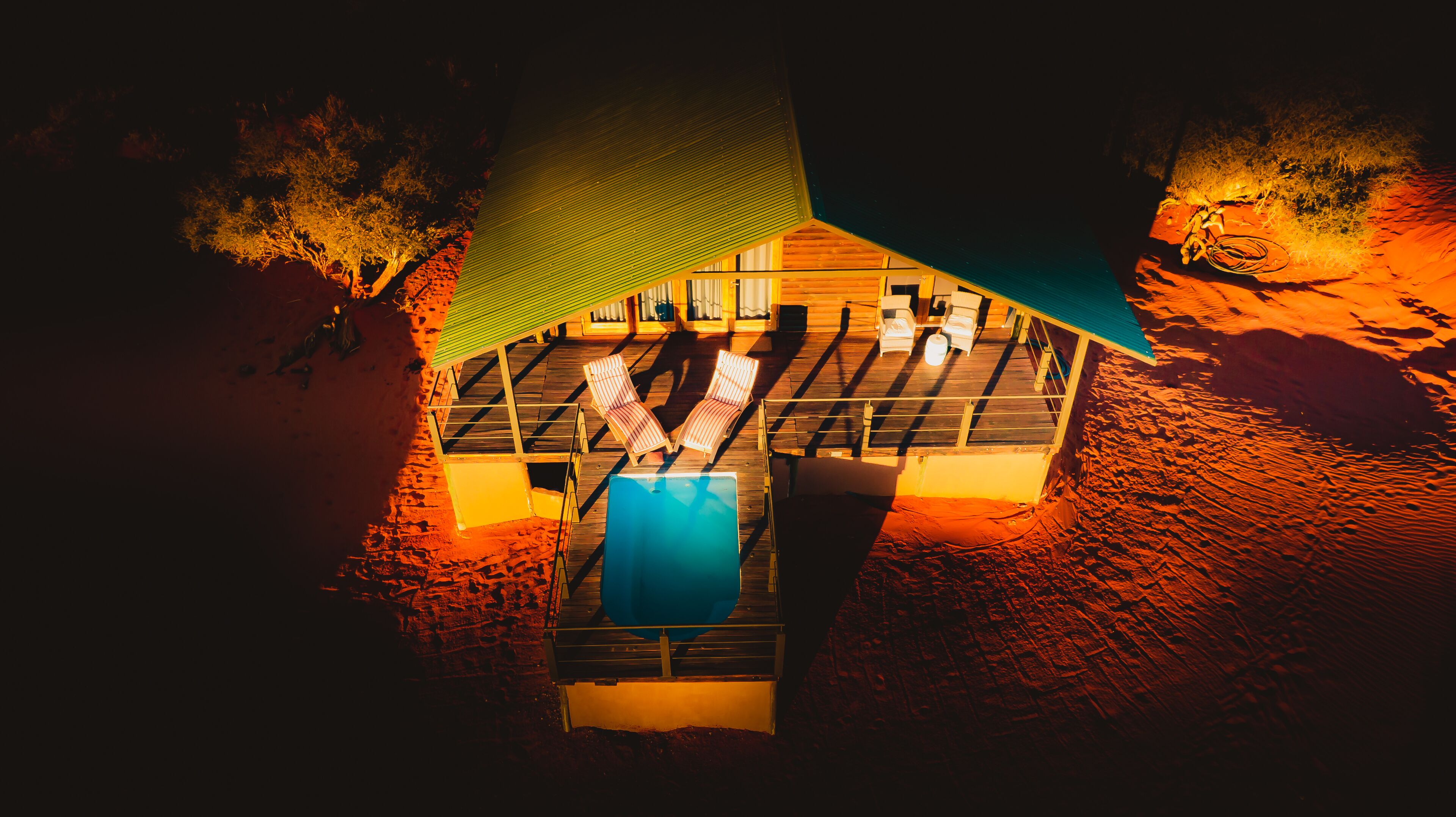 Un espace aménagé au bord de la piscine, avec des chaises longues et une piscine.