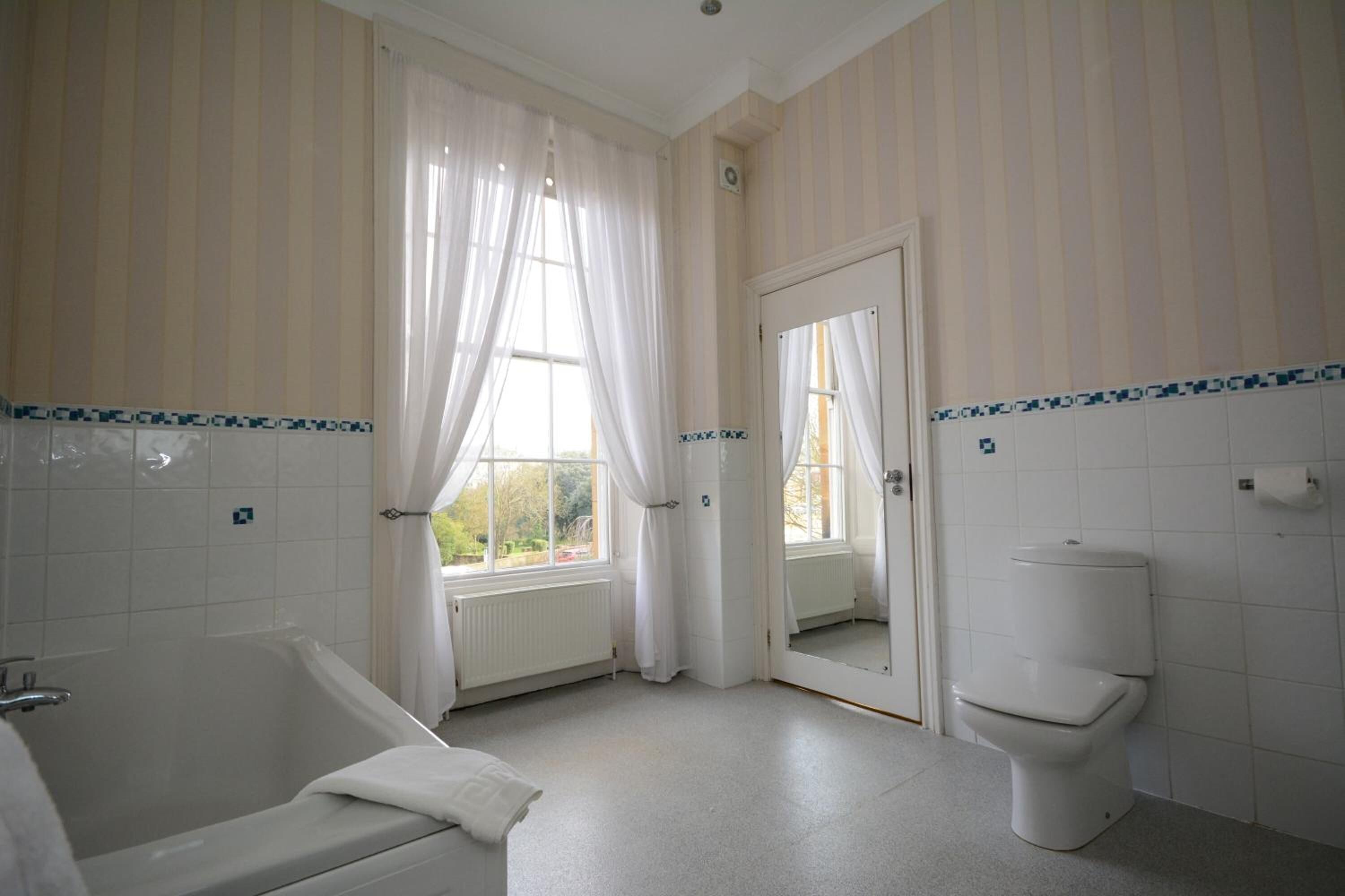 combined shower/bathtub, designer toiletries, hair dryer, towels