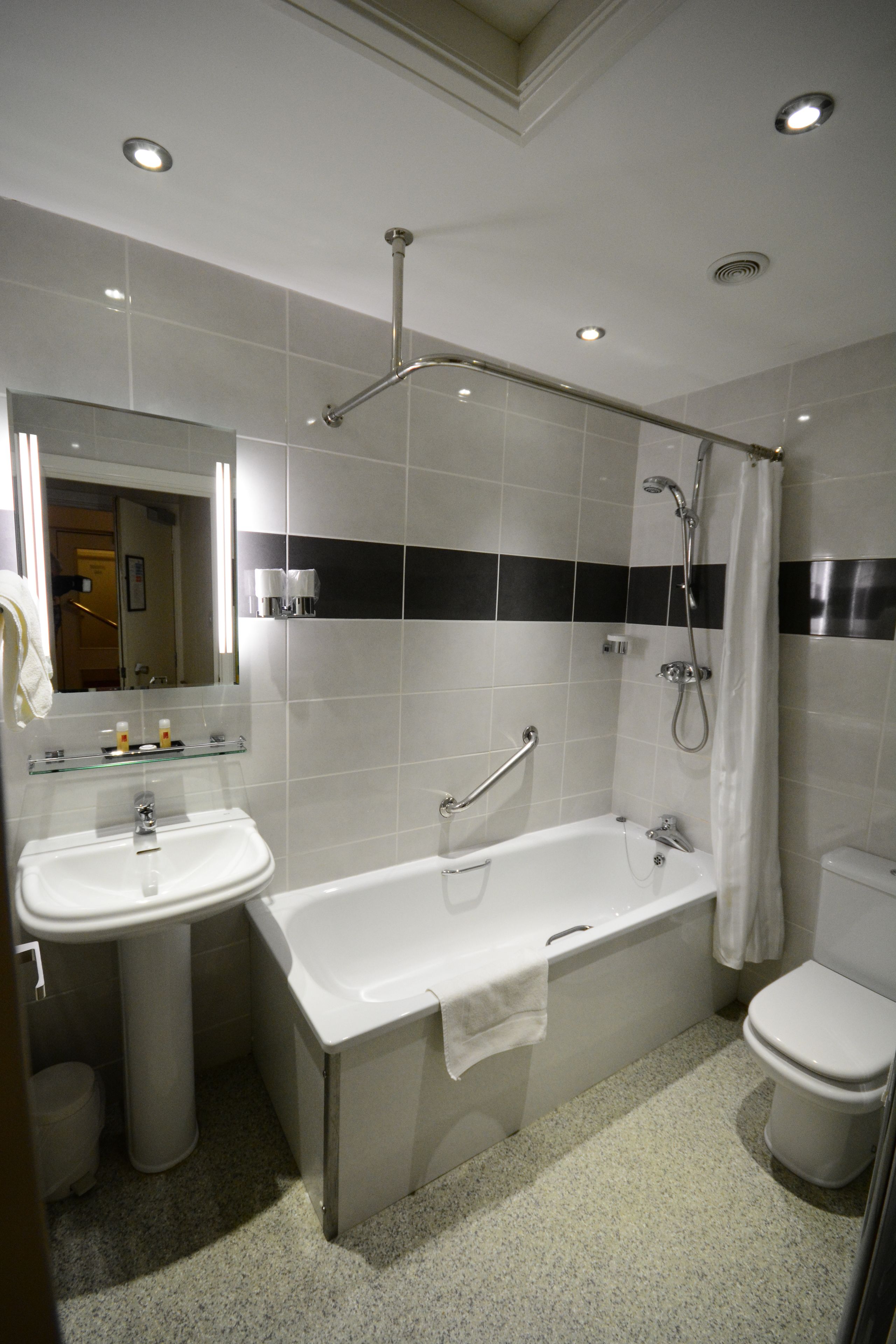 combined shower/bathtub, designer toiletries, hair dryer, towels