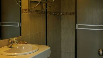A bathroom with a sink, toilet, and shower.