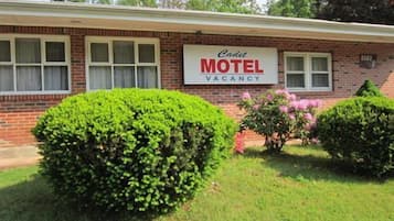 Simple, functional motel with a flat roof and small porch area.