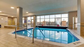 An indoor swimming pool with clear safety markings, a tiled floor, and large windows offering a view of the outside. - Drury Plaza Hotel Denver Westminster (Westminster)