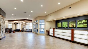 A spacious lobby with a reception desk, seating area, and large windows. - Drury Plaza Hotel Denver Westminster (Westminster)