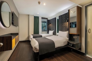 A hotel room with two beds, a large mirror, a TV, and a wardrobe. - Point A London Liverpool Street  (London)